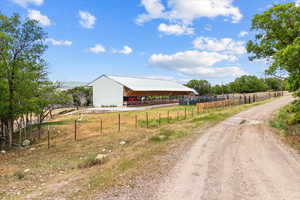 View of road with a rural view and a pole building