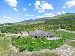 View of subject property featuring mountains and a forest