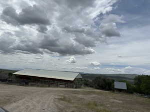 View of outdoor structure featuring a rural view, a mountain view, and a old grainery structure.