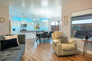 Living room featuring a chandelier and light wood-type flooring
