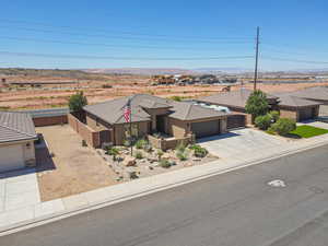 View of front of home featuring driveway, a garage, a mountain view, and stucco siding