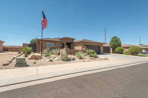 View of front facade featuring concrete driveway, an attached garage, and stucco siding