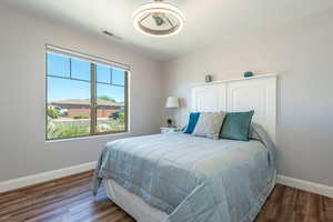 Bedroom with baseboards and wood finished floors