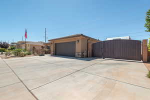 Garage featuring a gate and driveway