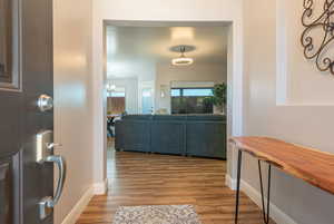 Hall featuring wood finished floors and baseboards