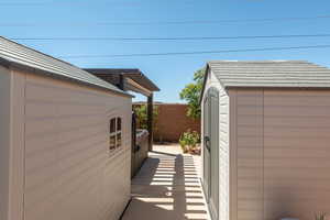 View of property exterior with a storage shed
