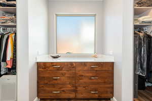 Walk in closet featuring wood finished floors