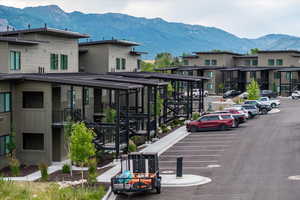 Uncovered parking lot with a mountain view, stairway, and a residential view