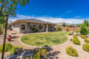 Rear view of property with stucco siding