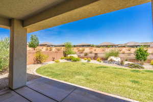 Fenced backyard featuring a patio and a residential view