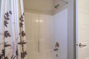 Full bathroom with shower / tub combo with curtain