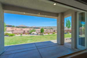 Fenced backyard with a patio area and a residential view