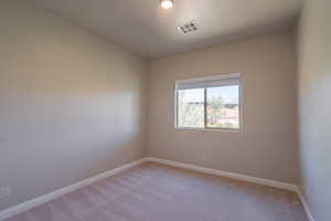 Unfurnished room with light colored carpet