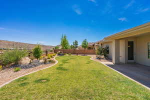 Fenced backyard with a patio area and a mountain view