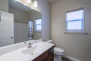 Bathroom featuring vanity, wood finished floors, and curtained shower