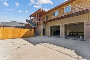 Rear view of house with concrete driveway and an attached garage