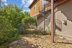 View of home's exterior with stairs and stucco siding