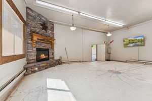 Unfurnished living room with baseboard heating and a fireplace