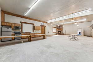 Garage with a fireplace and stainless steel fridge