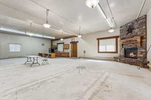 Unfurnished living room with a stone fireplace