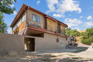 Rear view of house featuring stucco siding