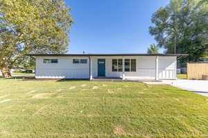 View of front of house featuring a front yard and a porch