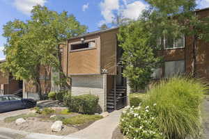 View of front of home featuring stairway and brick siding