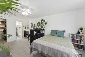 Bedroom featuring carpet floors, a spacious closet, ensuite bathroom, and ceiling fan
