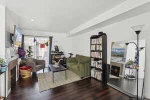 Living area featuring a high end fireplace and hardwood / wood-style floors