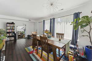 Dining room featuring dark wood-type flooring