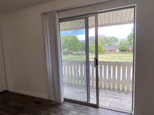 Entryway with wood finished floors and baseboards