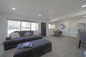 Living area with recessed lighting and light wood finished floors