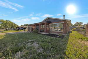 Back of house featuring brick siding and concrete driveway