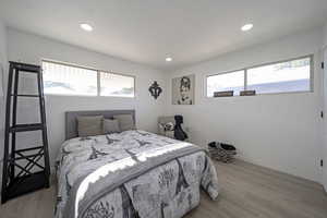 Bedroom featuring light wood finished floors and recessed lighting