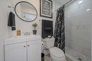 Full bathroom with vanity and tiled shower