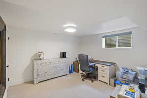 Home office with light carpet