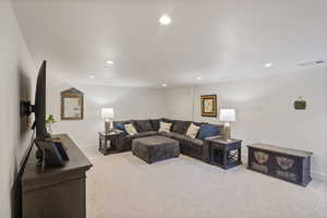 Living room featuring light carpet and recessed lighting