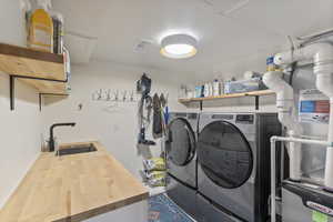 Washroom featuring washer and dryer and heating unit