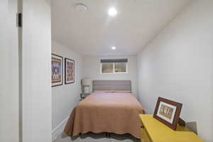 Carpeted bedroom featuring recessed lighting and baseboards