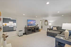 Living room with recessed lighting and light carpet