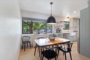 Dining room featuring light wood-style flooring and recessed lighting