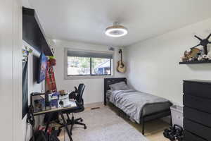 Bedroom featuring a desk and wood finished floors
