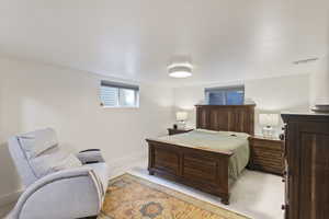 Bedroom with light carpet and baseboards