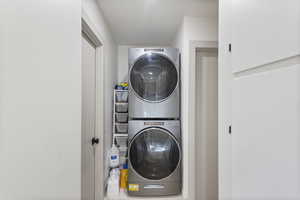 Laundry area with stacked washer and clothes dryer