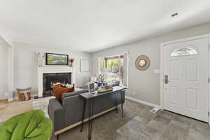 Living room with a premium fireplace and baseboards