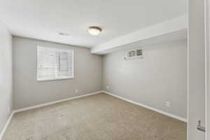 Empty room with carpet flooring and baseboards