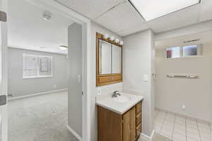 Bathroom featuring plenty of natural light, vanity, and tile patterned floors
