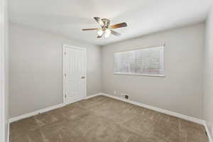 Spare room with carpet floors and ceiling fan