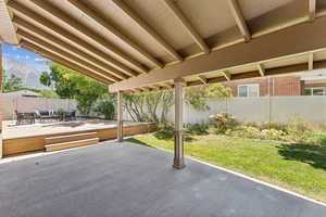 Fenced backyard with a patio and a deck with mountain view