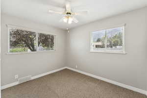 Spare room with carpet floors and ceiling fan